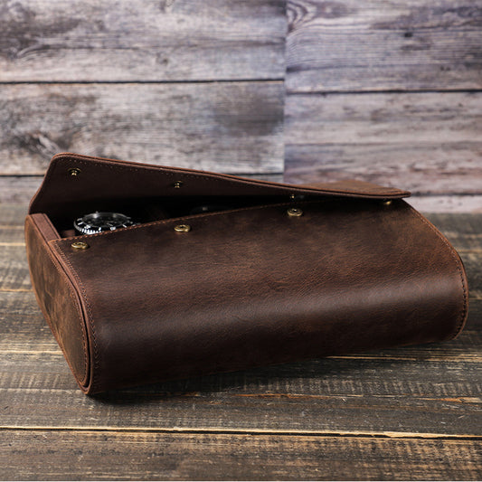Brown leather clutch bag on a wooden surface with a rustic background