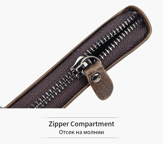 Close-up of a zipper compartment with a brown leather pull on a white background