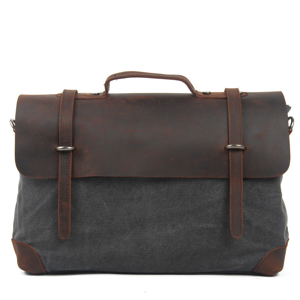 Gray bag with brown leather accents on a white background