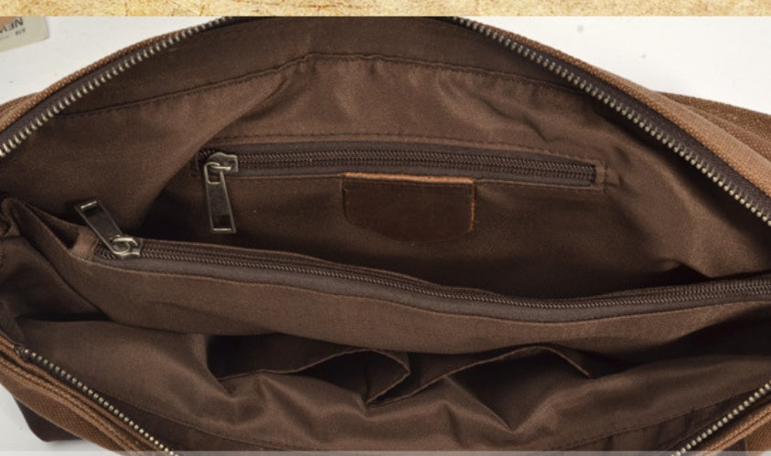 Brown leather bag with zippers on a light brown background