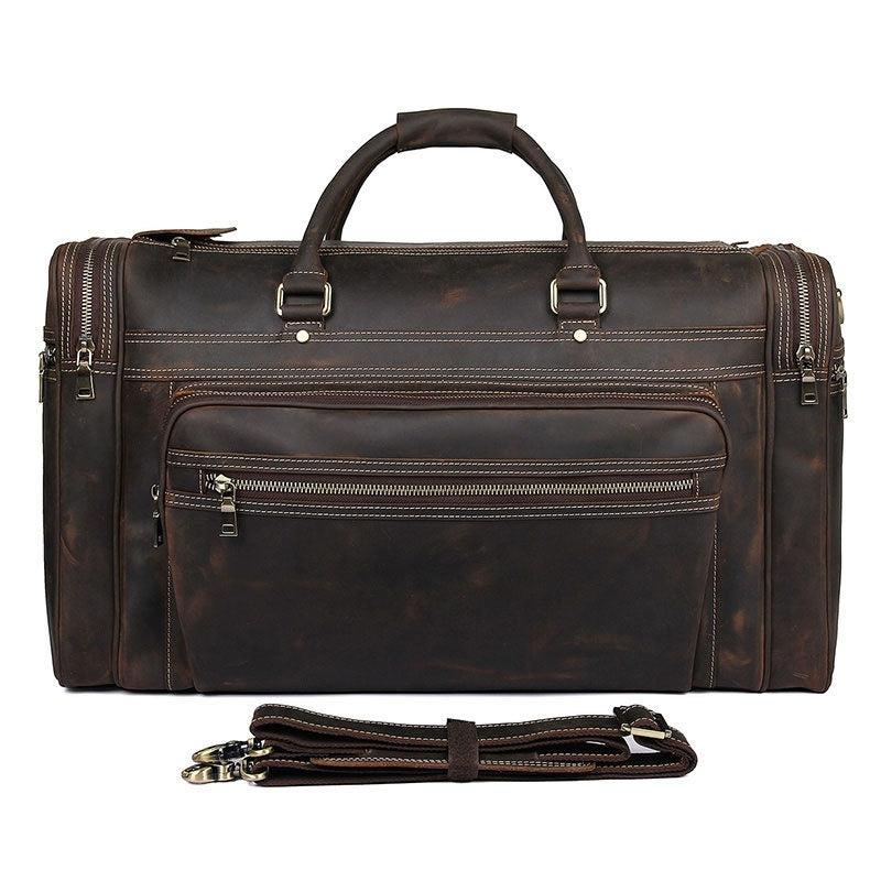 Brown leather duffel bag with shoulder strap on a white background