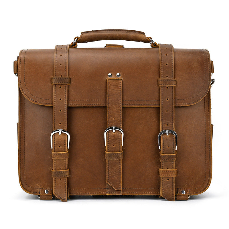 Brown leather briefcase with straps on a white background