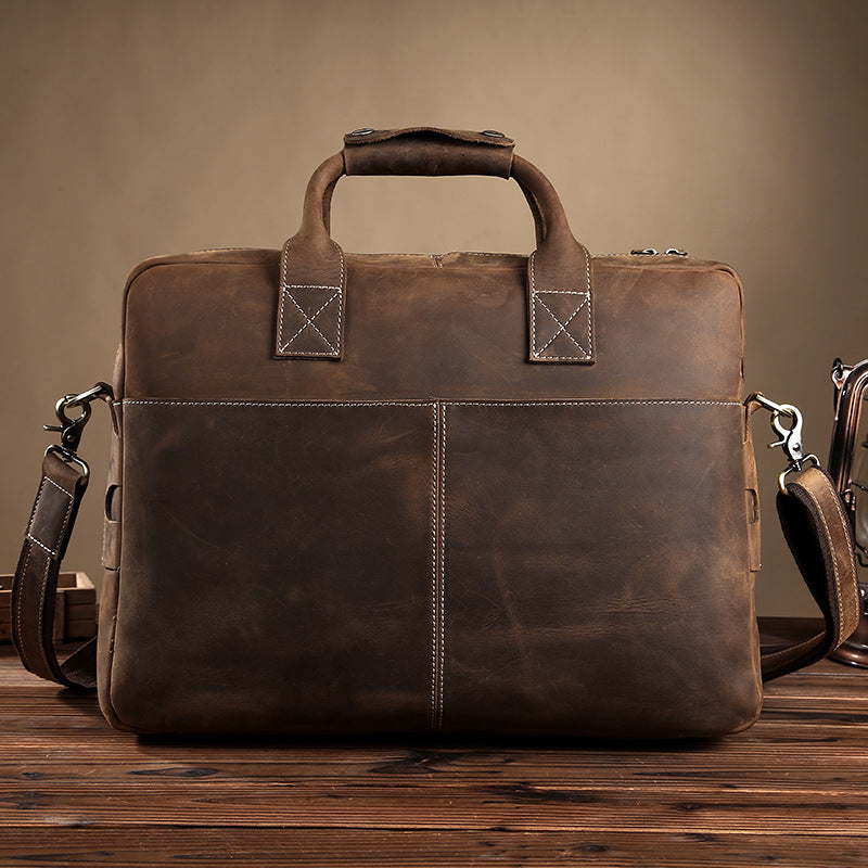 Brown leather briefcase on a wooden surface with a brown background