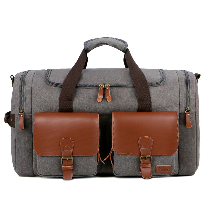Gray duffel bag with brown leather accents on a white background