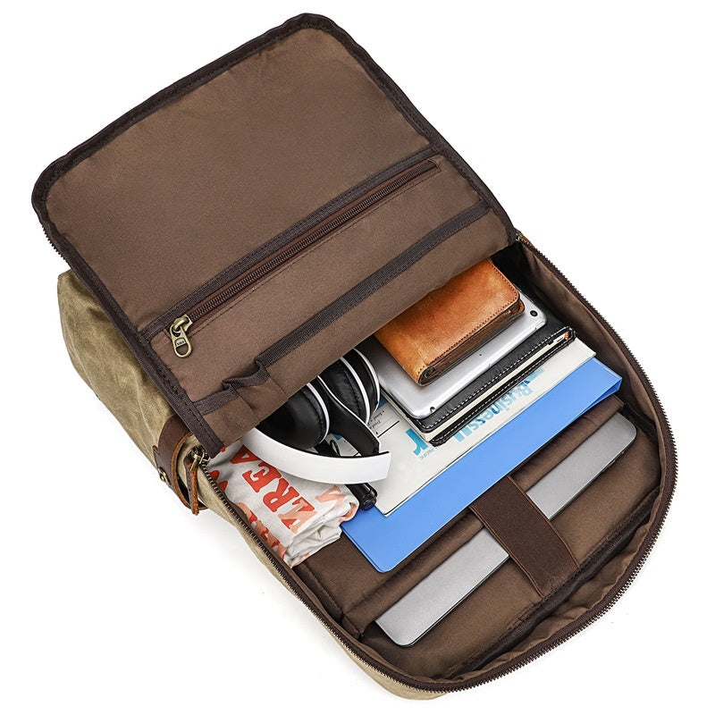 Open brown travel bag with various items on a white background