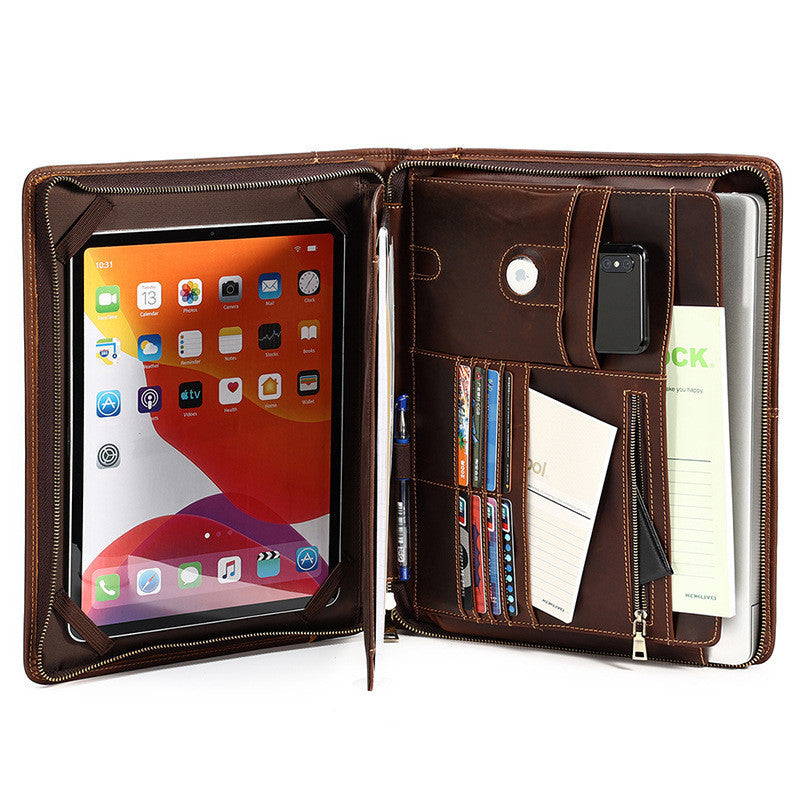 Brown leather folio case with tablet, phone, and documents inside on a white background