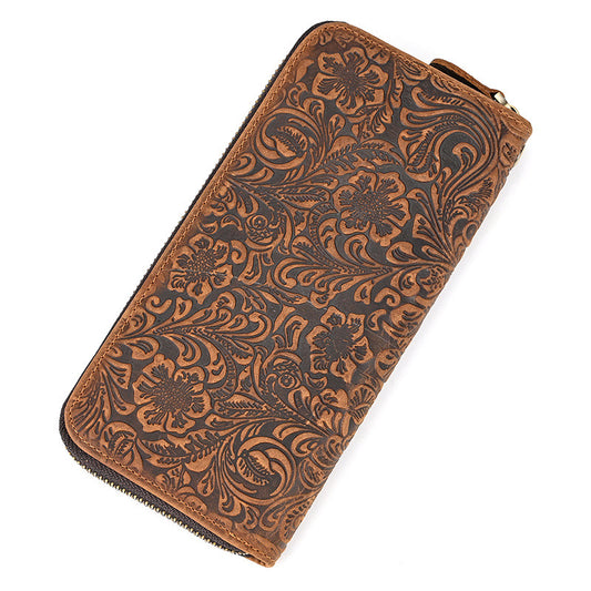 Brown leather wallet with intricate floral patterns on a white background