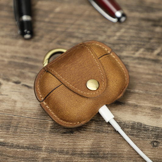 Brown leather case with a white cable on a wooden surface