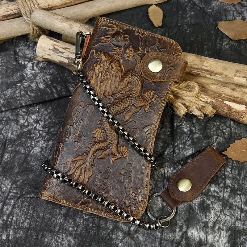 Brown leather wallet with embossed designs on a textured surface