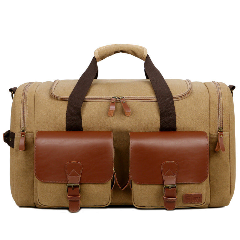 Beige duffel bag with brown leather accents on a white background