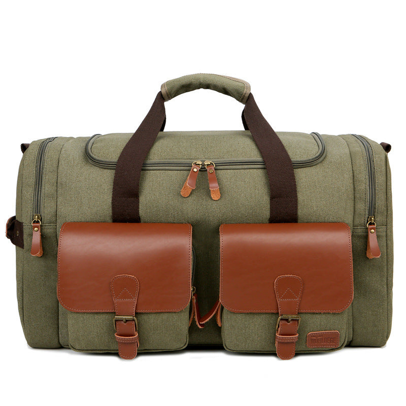 Green duffel bag with brown leather straps and pockets on a white background
