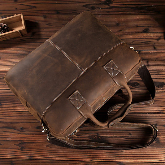 Brown leather bag on a wooden surface