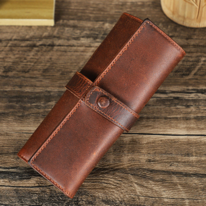 Brown leather wallet on a wooden surface