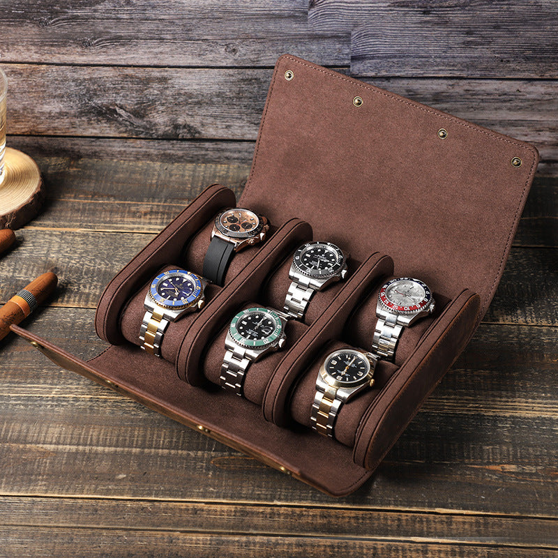 Brown leather watch holder with six watches on a wooden surface