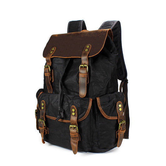 Black backpack with brown leather straps on a white background