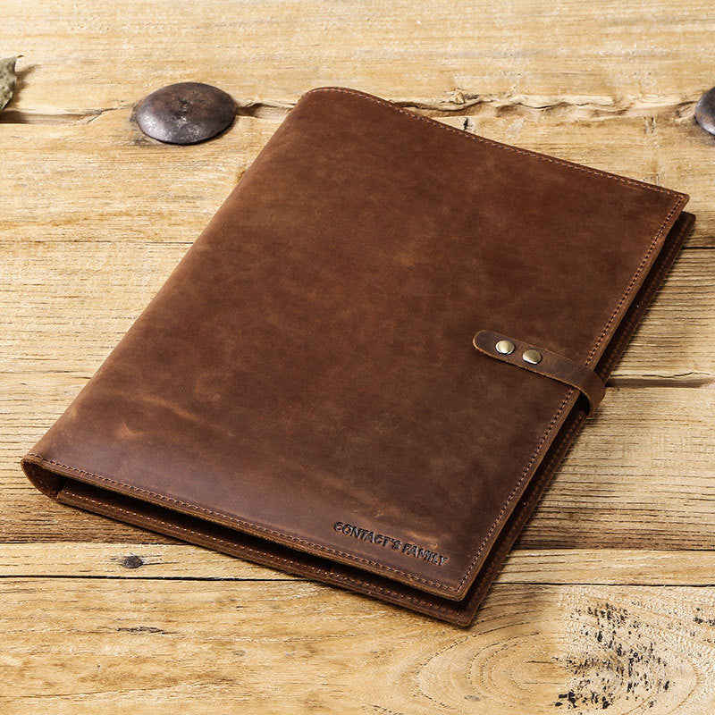 Brown leather notebook on a wooden surface