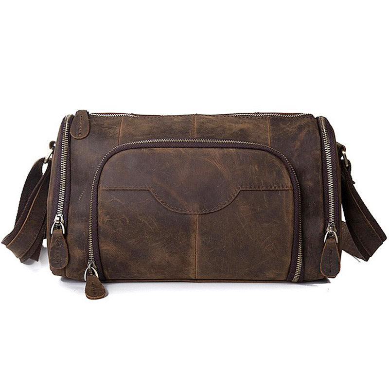 Brown leather duffel bag with multiple zippers on a white background