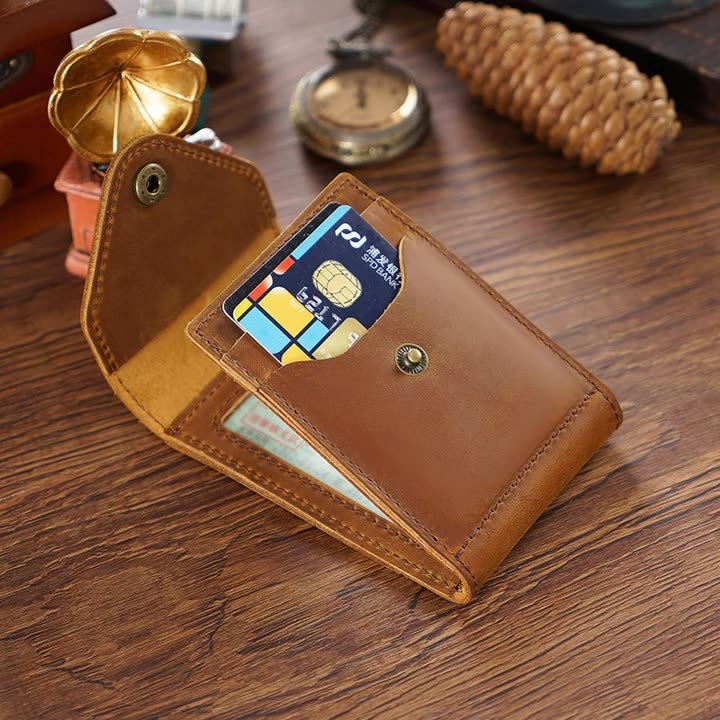 Brown leather wallet with card slots on a wooden surface