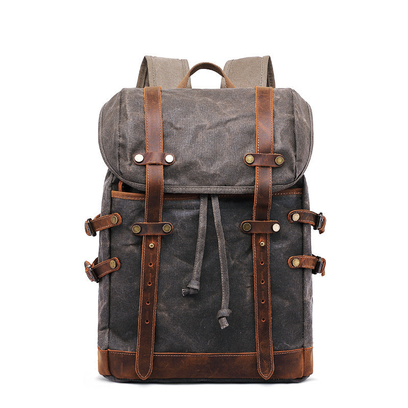 Gray backpack with brown leather straps on a white background
