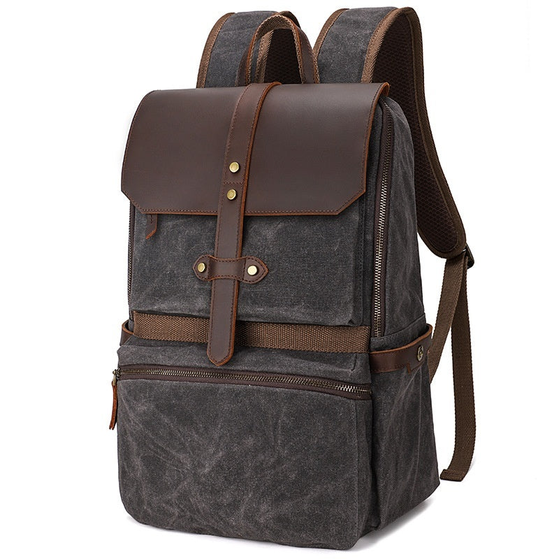 Gray backpack with brown leather accents on a white background