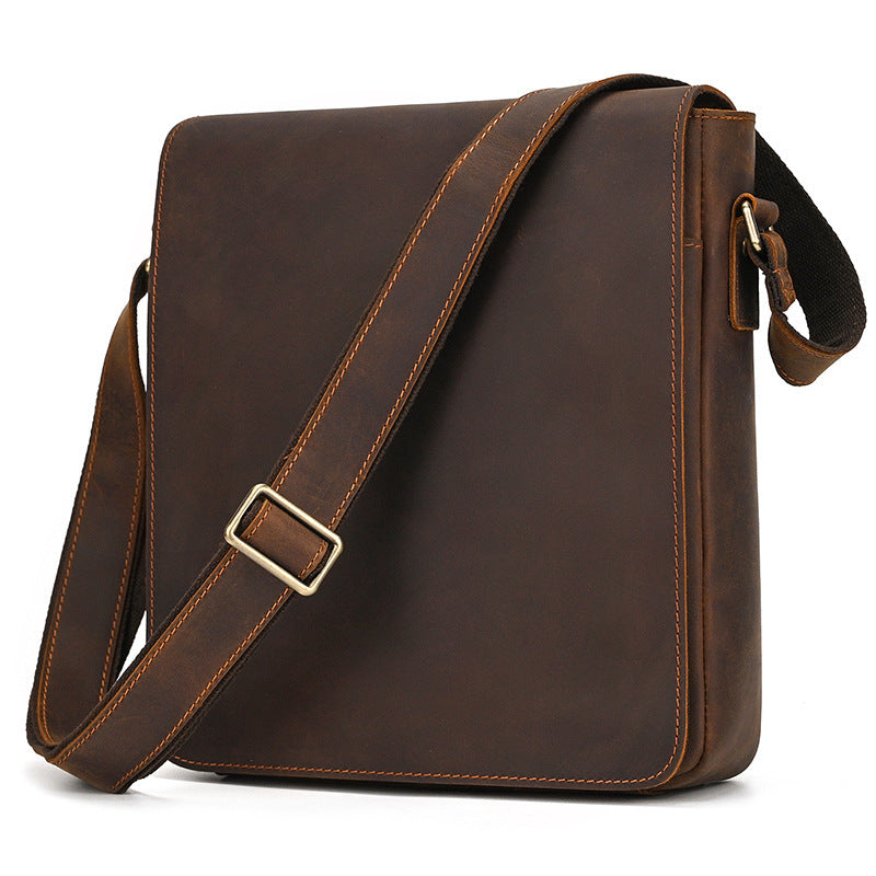 Brown leather shoulder bag with a gold buckle on a white background