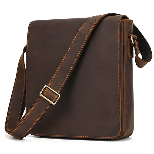 Brown leather shoulder bag with a gold buckle on a white background