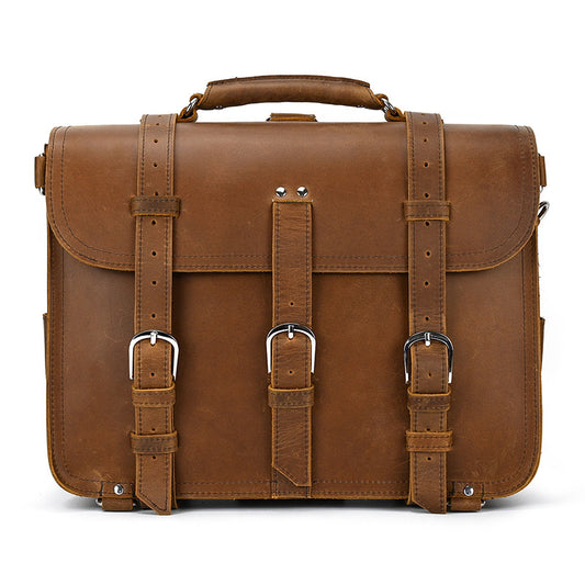 Brown leather briefcase with straps on a white background