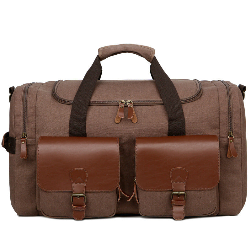 Brown duffel bag with leather accents on a white background
