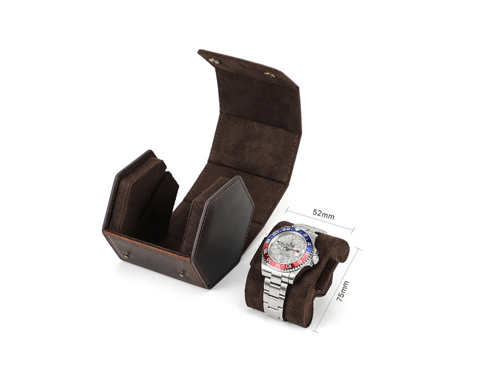 Brown suede watch display case with a watch on a white background