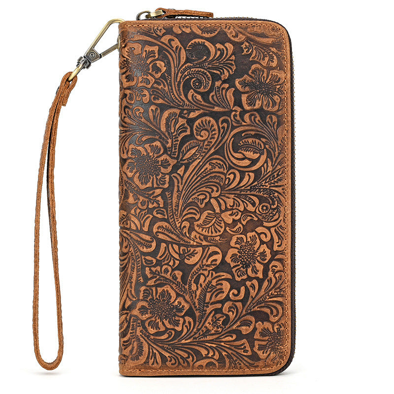Brown leather wallet with intricate floral patterns on a white background