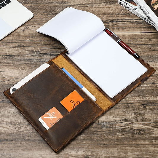 Brown leather wallet with card slots on a wooden surface