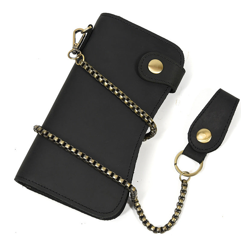 Black leather wallet with gold chain and strap on a white background
