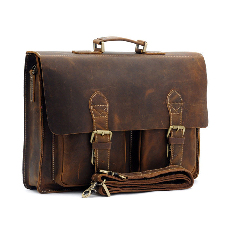 Brown leather satchel bag with straps on a white background