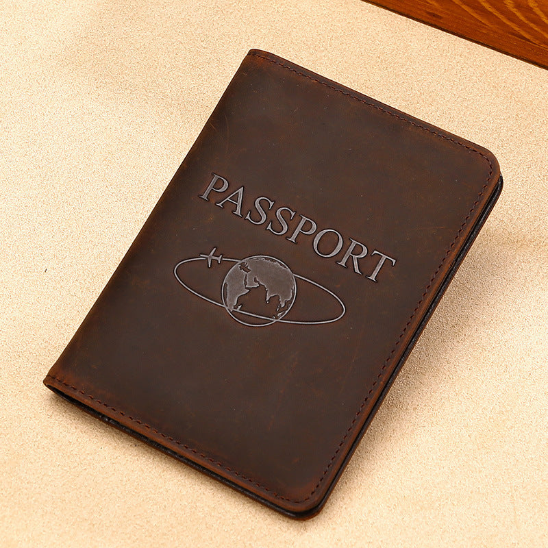 Brown leather passport holder with 'PASSPORT' embossed on it, on a beige surface.