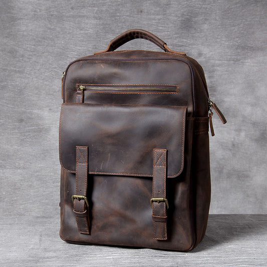 Brown leather backpack on a gray background