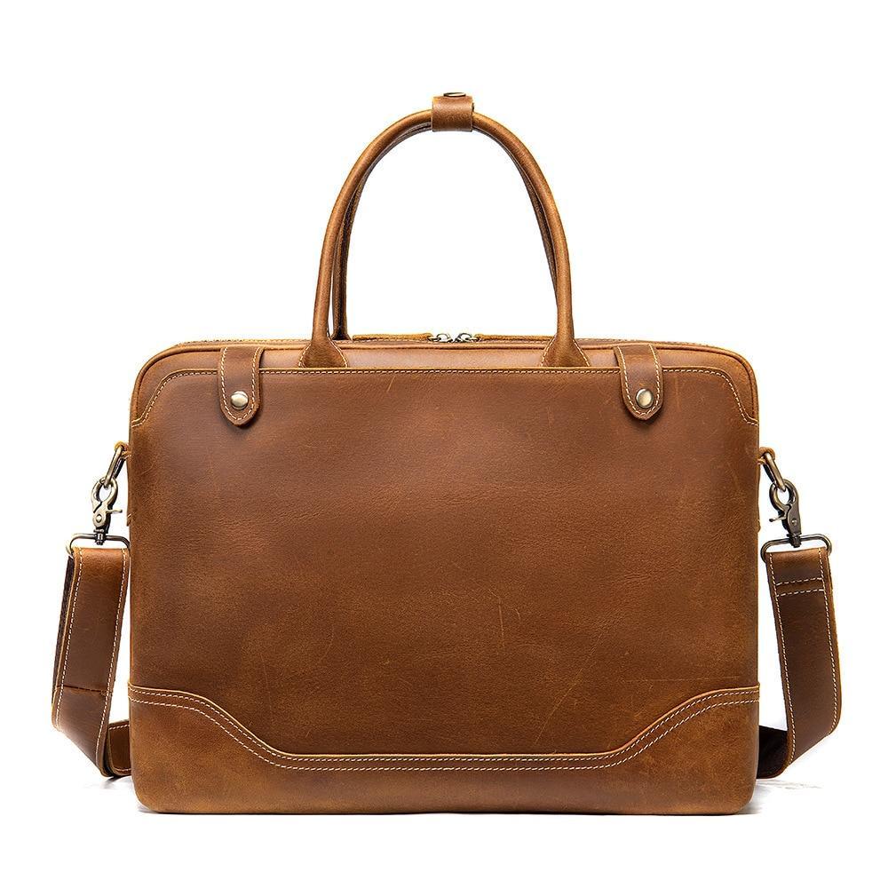 Brown leather briefcase with shoulder strap on a white background