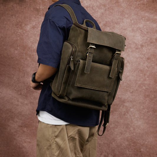 Person wearing a brown leather backpack against a brown background