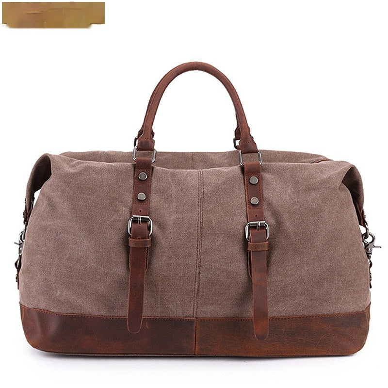 Brown canvas duffel bag with leather straps on a white background