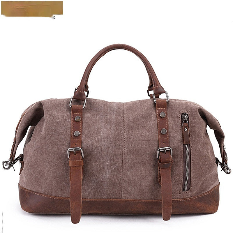 Brown canvas duffel bag with leather accents on a white background