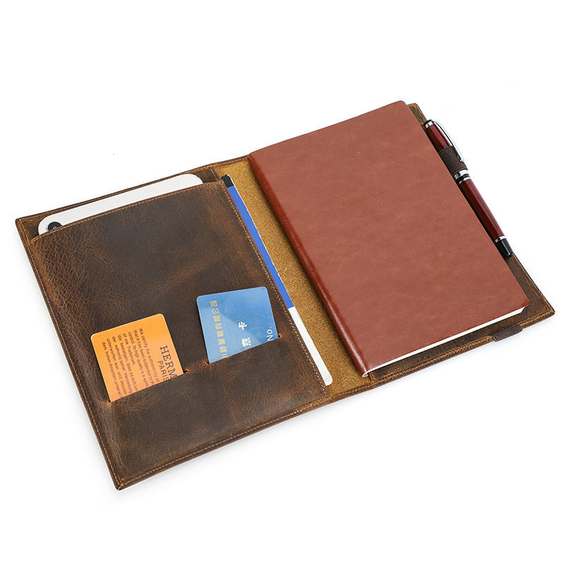 Brown leather wallet with card slots and a pen on a white background