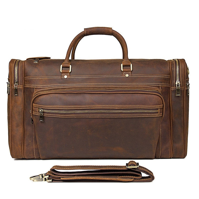 Brown leather duffel bag with shoulder strap on a white background