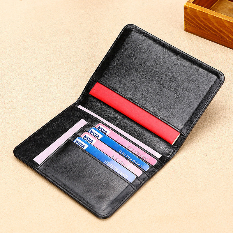 Black leather wallet with multiple cards on a beige background