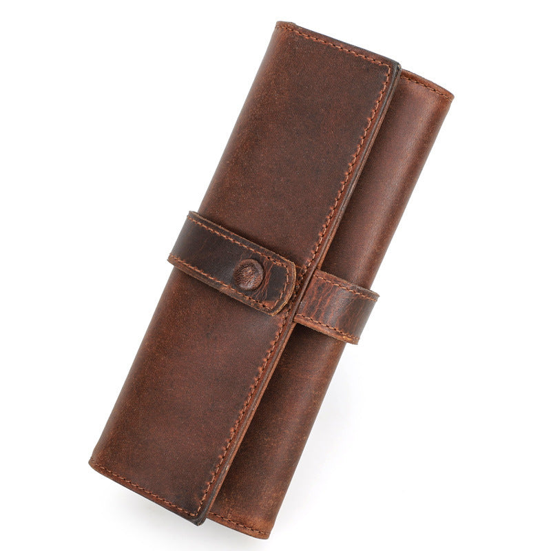 Brown leather wallet with a strap on a white background
