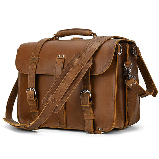 Brown leather satchel bag with shoulder strap on a white background