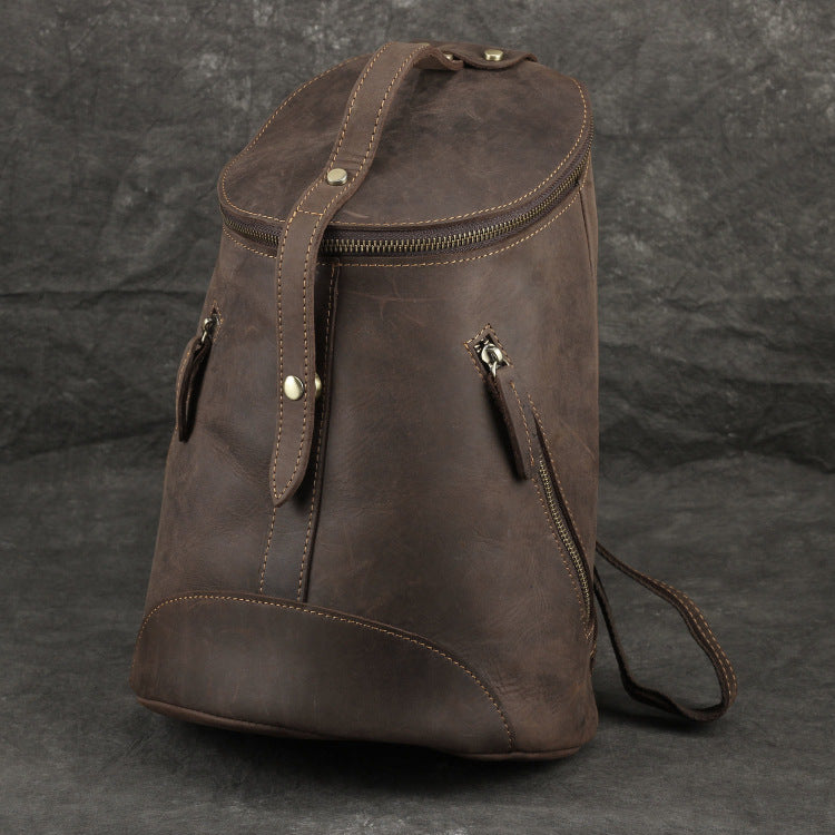 Brown leather backpack on a dark gray background
