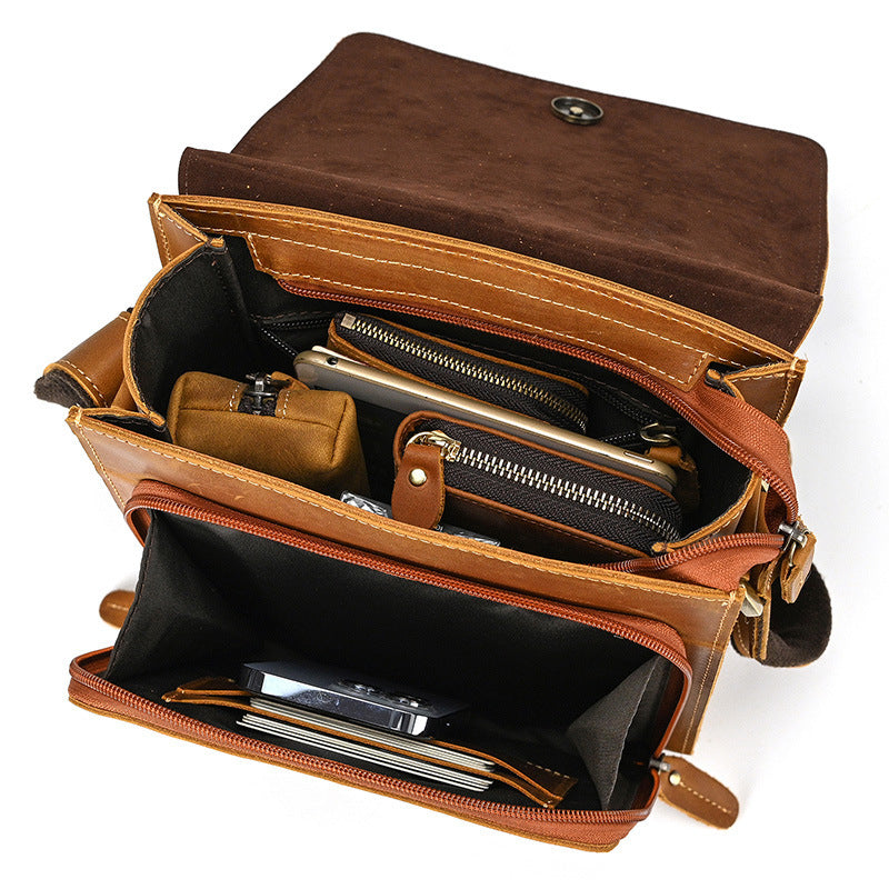Brown leather briefcase with compartments on a white background