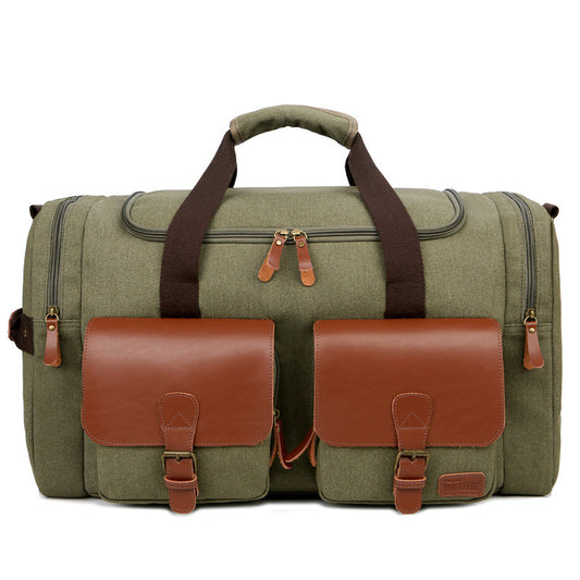 Green duffel bag with brown leather straps and pockets on a white background