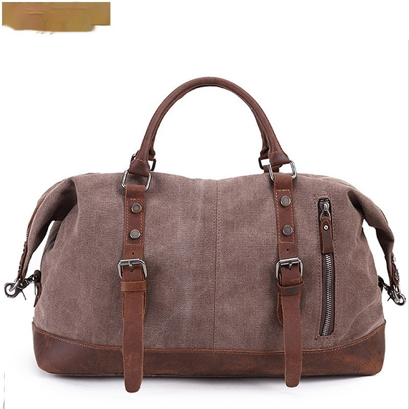 Brown canvas duffel bag with leather accents on a white background