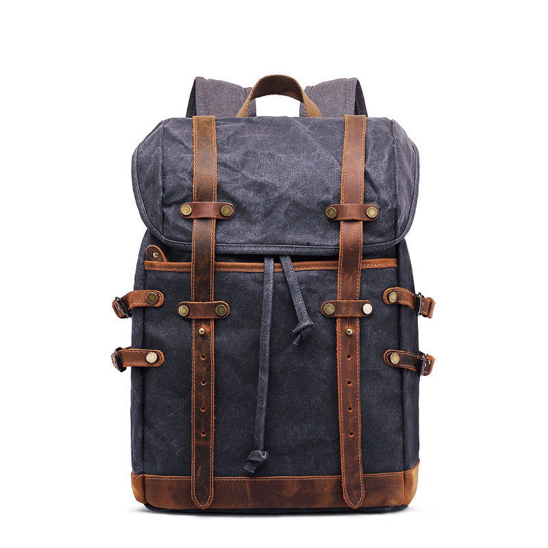 Gray backpack with brown leather straps on a white background
